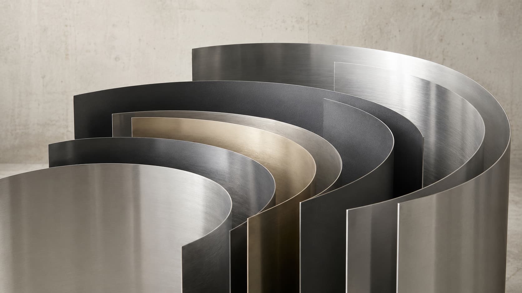 Stainless Steel Coils, Stainless Steel Coils with different metallic finishes are arranged upright to show their rolled sheet form.